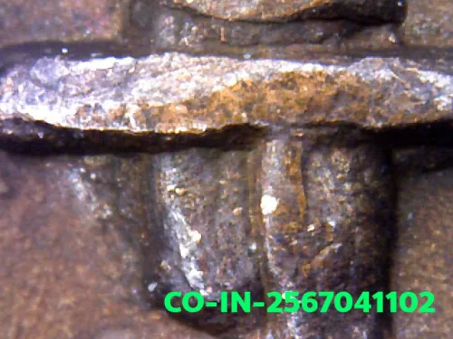 1000× magnification — Luang Pu Waen coin, Chana Suek (victory), Copper, Wat Doi