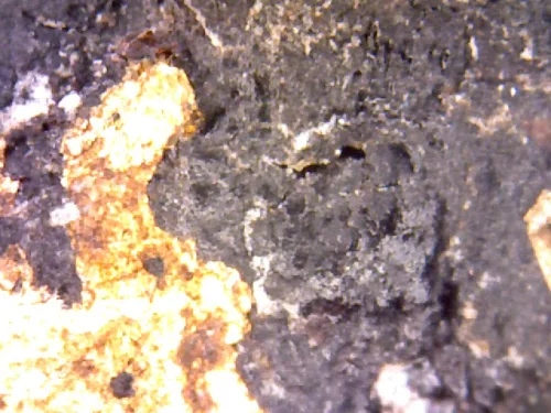 1000× magnification — Phra Pidta by Luang Phor Kaew, flat back, Powder with